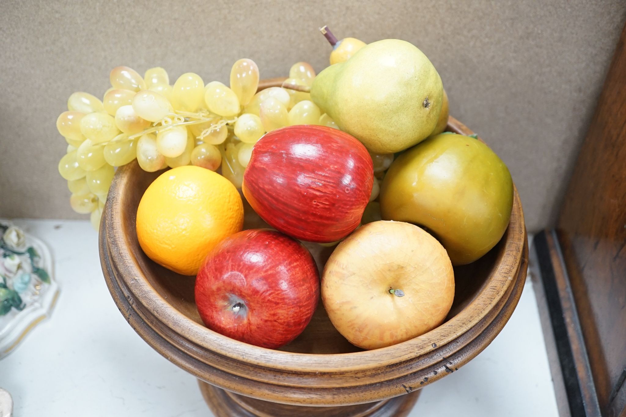 Faux fruit on a turned wood pedestal bowl